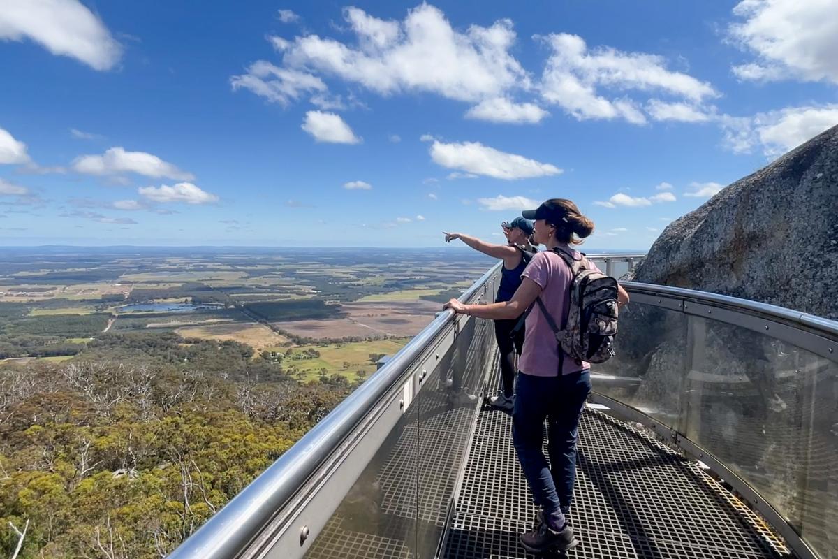 Visitors enjoying the view across the Porongurup countryside from Castle Rock's Granite Skywalk